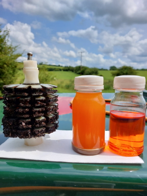 A used filter, next to the original fuel sample, and the final, polished fuel sample. Clearly better. A used filter, next to the original fuel sample, and the final, polished fuel sample. Clearly better.